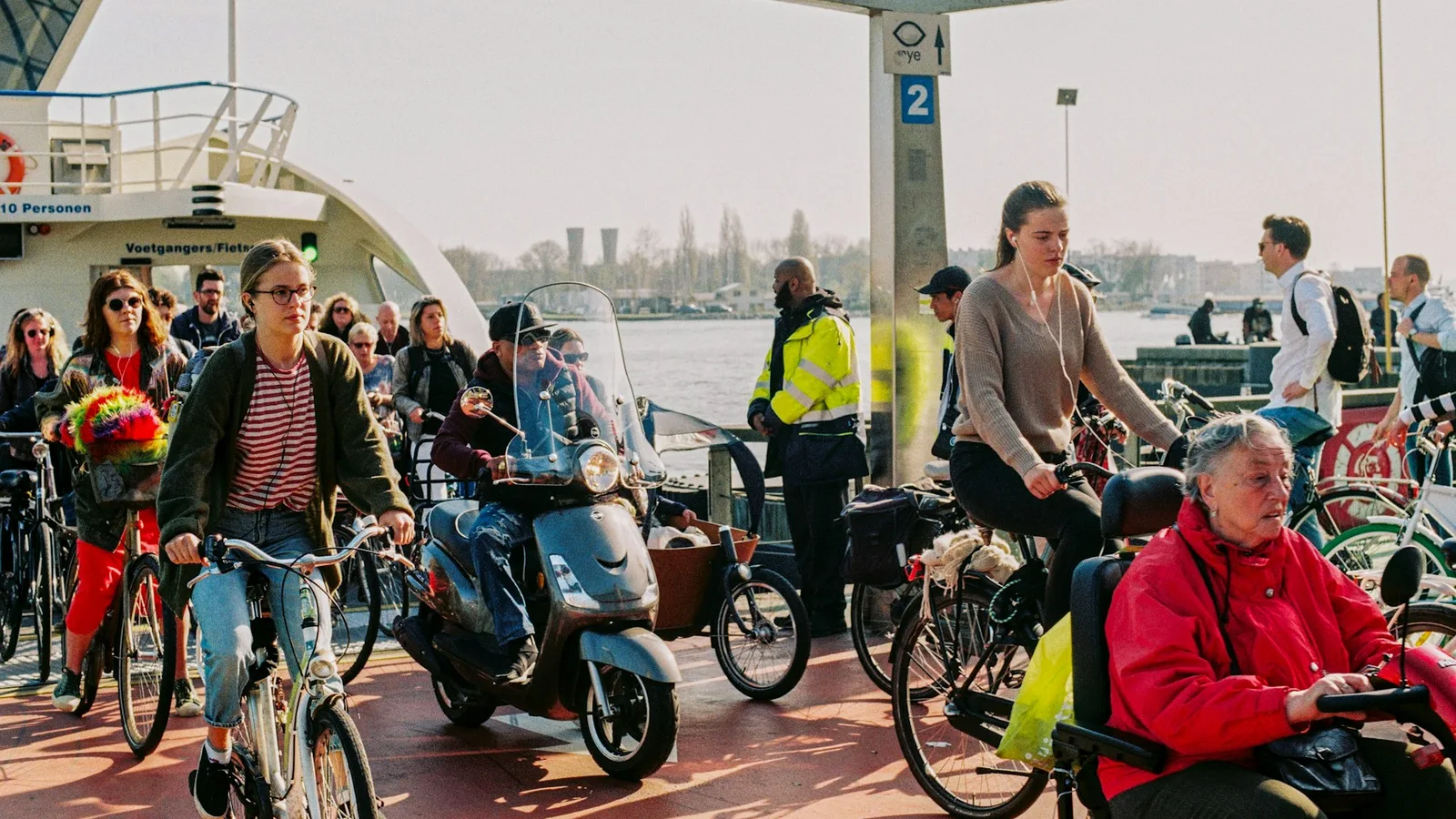 Cyclists and pedestrians leaving the free IJ ferry in Amsterdam